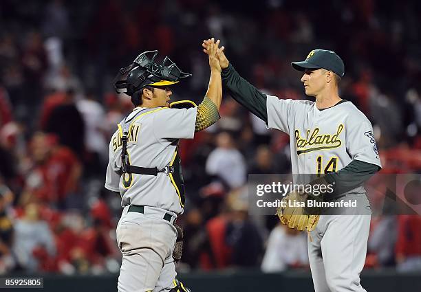 Catcher Kurt Suzuki and teammate Mark Ellis of the Oakland Athletics celebrate defeating the Los Angeles Angels of Anaheim 6-4 on April 7, 2009 in...