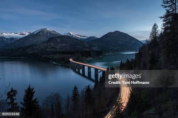 night at lake sylvensteinspeicher - mountain range road stock pictures, royalty-free photos & images