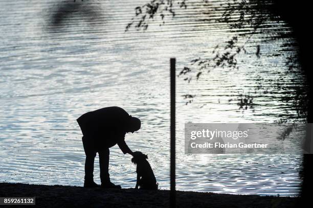 Man caresses his dog on October 08, 2017 in Berlin, Germany.