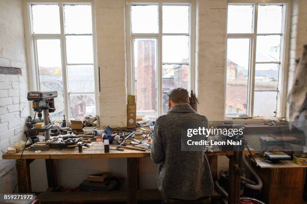 Traditional cutler Michael May works in his studio, where he makes pen, pocket and bowie knives, on November 8, 2016 in Sheffield, England. Michael...