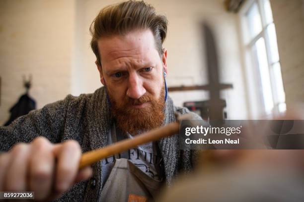 Traditional cutler Michael May works in his studio, where he makes pen, pocket and bowie knives, on November 8, 2016 in Sheffield, England. Michael...