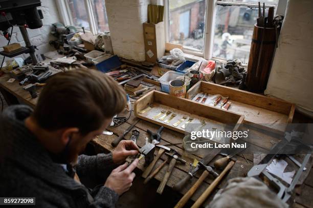 Traditional cutler Michael May works in his studio, where he makes pen, pocket and bowie knives, on November 8, 2016 in Sheffield, England. Michael...