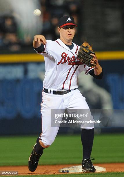 Infielder Kelly Johnson of the Atlanta Braves throws to first base against the Washington Nationals April 10, 2009 in Atlanta, Georgia.