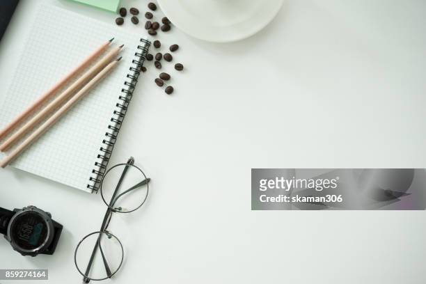 top view office working desk with notepad and tablet ,keyboard and sunglasses relaxing drink with coffee cup and roasted coffee seed - coffee drink on white stock pictures, royalty-free photos & images