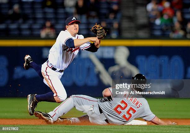 Infielder Kelly Johnson of the Atlanta Braves throws to first base against the Washington Nationals April 10, 2009 in Atlanta, Georgia.