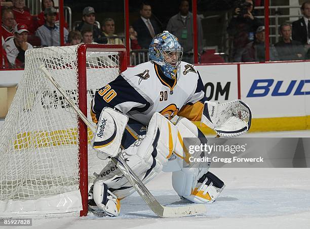 Ryan Miller of the Buffalo Sabres crouches in the crease during a NHL game against the Carolina Hurricanes on April 9, 2009 at RBC Center in Raleigh,...
