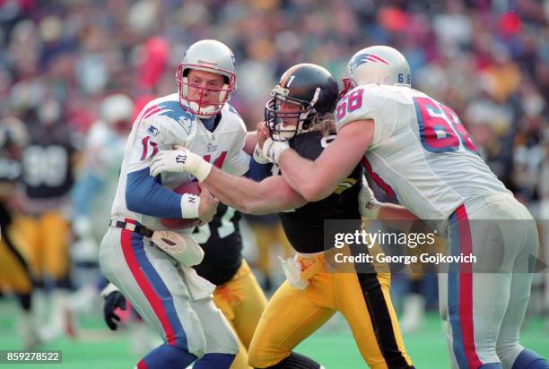 Linebacker Kevin Greene of the Pittsburgh Steelers sacks quarterback Drew Bledsoe of the New England Patriots as he is blocked by offensive lineman...