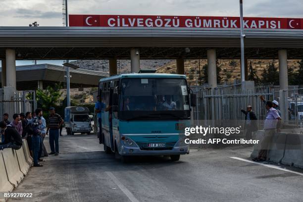 Bus carrying Syrian people crosses the cilvegozu border gate to Turkish side on october 9, 2017 at Reyhanli district in Hatay. The Turkish army has...