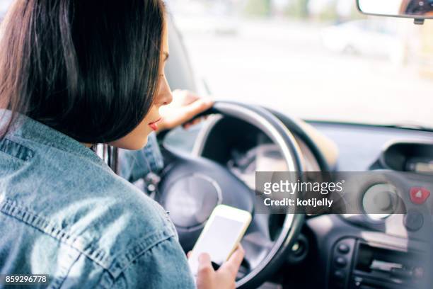 woman in a car - distracted driving stock pictures, royalty-free photos & images