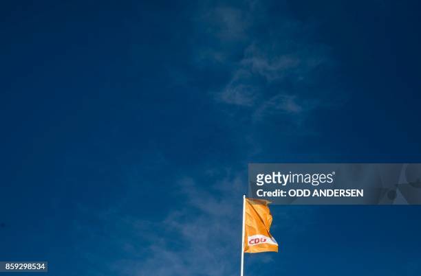 Picture taken on October 9, 2017 shows a flag with the logo of the German Christian Democratic Union party fluttering above the party´s headquarters...