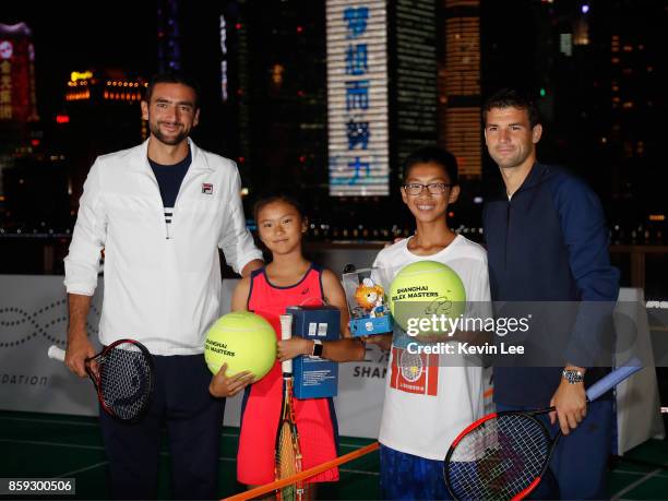 Marin Cilic and Grigor Dimitrov pose for a picture with some children after their mini-tournament at Fosun Foundation at the Bund on Day 2 of 2017...