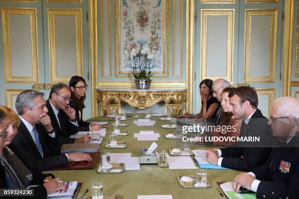 French President Emmanuel Macron , flanked by his Chief of Staff, Admiral Bernard Rogel and his diplomatic adviser, Philippe Etienne talks with the...