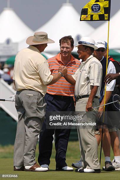 Larry Ziegler, Tom Watson and Chi Chi Rodriquez leave the 18th hole after competing in the first round of the 2005 Liberty Mutual Legends of Golf...