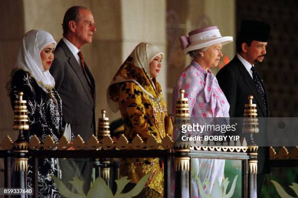 Queen Elizabeth II and the Duke of Edinburgh , accompanied by Brunei Sultan Hassanal Bolkiah , Queen Raja Isteri Pengiran Anak Hajah Saleha and Royal...