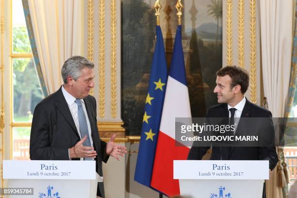 French President Emmanuel Macron and the UN High Commissioner for Refugees Filippo Grandi speak during a joint press conference following their...