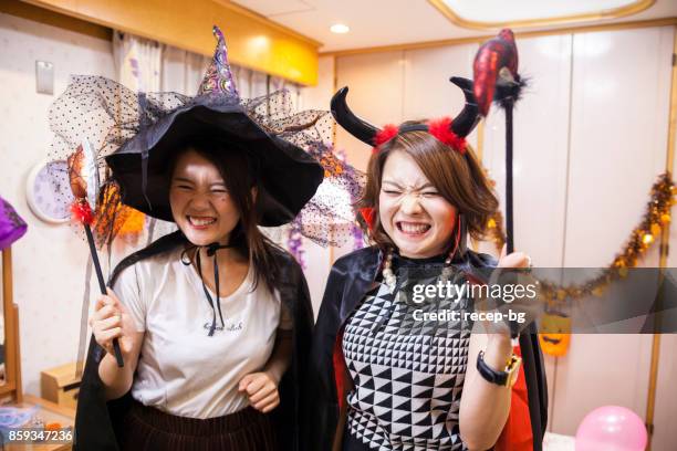 women enjoying the halloween party - party with the devil stock pictures, royalty-free photos & images