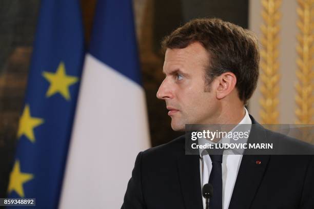 French President Emmanuel Macron looks at the UN High Commissioner for Refugees during a joint press conference with the following their meeting at...