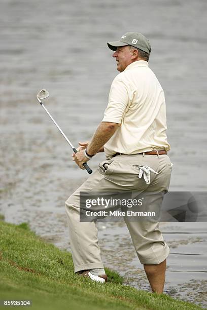 Larry Ziegler chips with one foot in the water on the 18th hole during the first round of the 2005 Allianz Championship at the Tournament Club of...