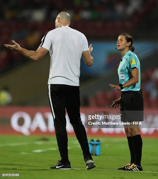 Fourth Official Kateryna Monzul talks to Danny Hay, Head Coach of New Zealand during the FIFA U-17 World Cup India 2017 group B match between...