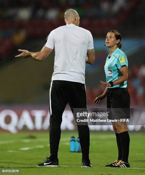 Fourth Official Kateryna Monzul talks to Danny Hay, Head Coach of New Zealand during the FIFA U-17 World Cup India 2017 group B match between...