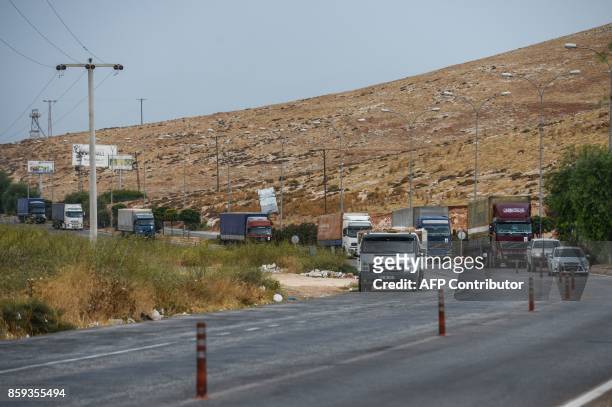 Aid trucks escorted by a United Nation vehicle drive to Cilvegozu border gate to cross into Syria at the Turkey-Syria border in Reyhanli, Hatay...