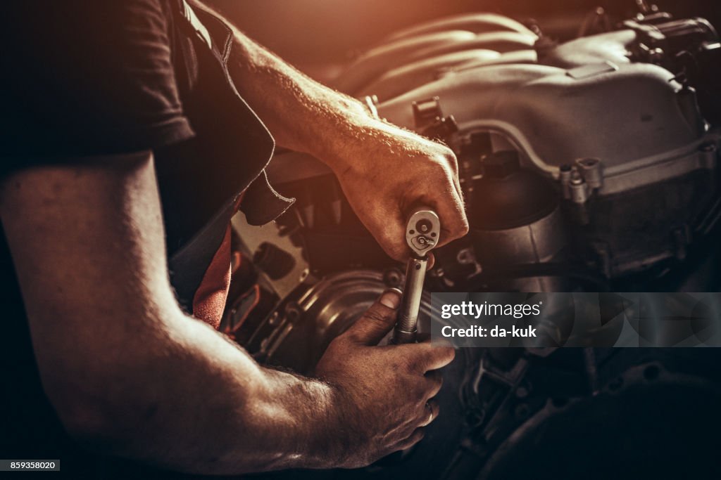 Repairing V10 engine in auto repair shop