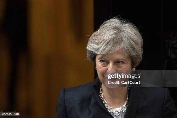 Britain's Prime Minister, Theresa May, leaves Downing Street to deliver a statement on Brexit to the House of Commons on October 9, 2017 in London,...