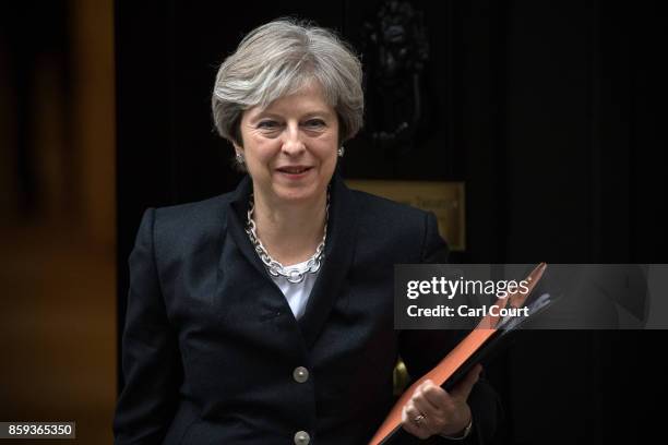 Britain's Prime Minister, Theresa May, leaves Downing Street to deliver a statement on Brexit to the House of Commons on October 9, 2017 in London,...