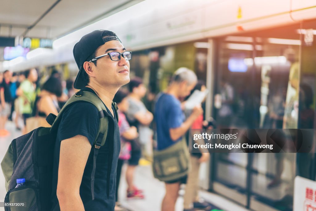 Young asian traveler waiting for transportation underground at Hong Kong MTR