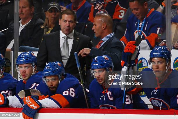 Head coach of the New York Islanders Doug Weight and Associate Coach Grag Cornin looks on from the bench during the game against the Buffalo Sabres...