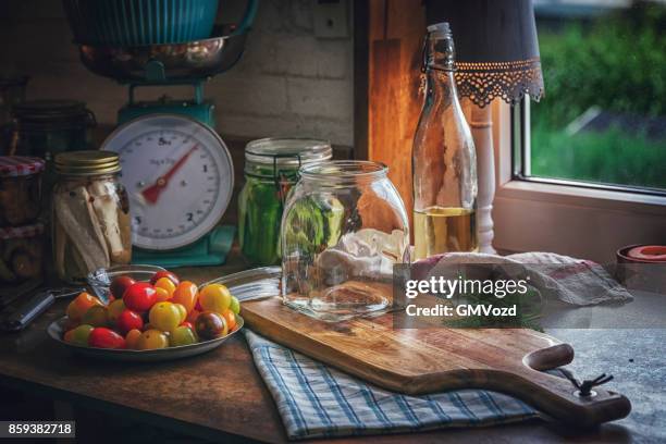 preserving organic mixed colored cherry tomatoes in jars - green tomato stock pictures, royalty-free photos & images