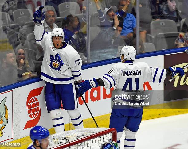 Richard Clune celebrates his goal with team mate Dmytro Timashov of the Toronto Marlies against the Utica Comets during AHL game action on October 7,...