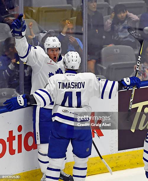 Richard Clune celebrates his goal with them mate Dmytro Timashov of the Toronto Marlies against the Utica Comets during AHL game action on October 7,...