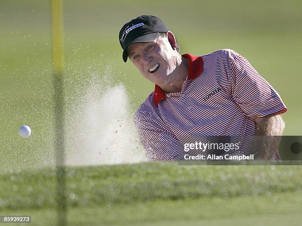 Gil Morgan works out of the sand on 18 and one putt for birdie to tie for the lead. Morgan shares the lead with Doug Tewell at 13 under par, during...