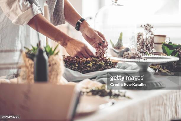 making a christmas wreath - table setting design scandinavian stock pictures, royalty-free photos & images