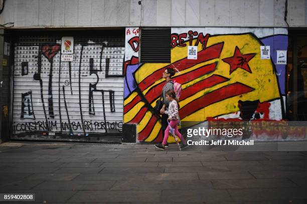 Catalans go about their daily business in the Vila de Gracia district ahead of tomorrow's parliamentary announcement on October 9, 2017 in Barcelona,...