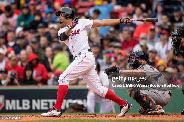 Xander Bogaerts of the Boston Red Sox hits a solo home run during the first inning of game four of the American League Division Series against the...