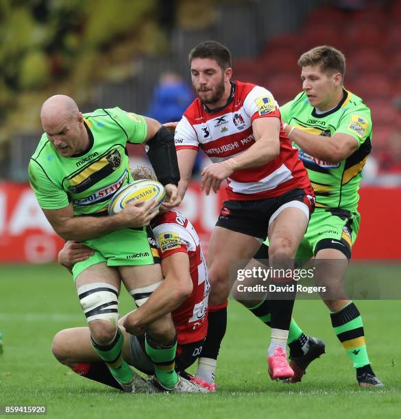 Sam Dickinson of Northampton is tackled by Billy Twelvetrees and Owen Williams during the Aviva Premiership match between Gloucester Rugby and...