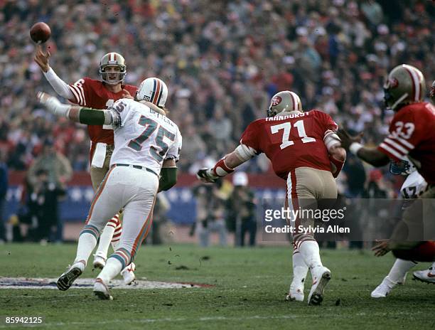 Miami Dolphins defensive end Doug Betters pressures San Francisco 49ers Hall of Fame quarterback Joe Montana during Super Bowl XIX, a 38-16 49ers...