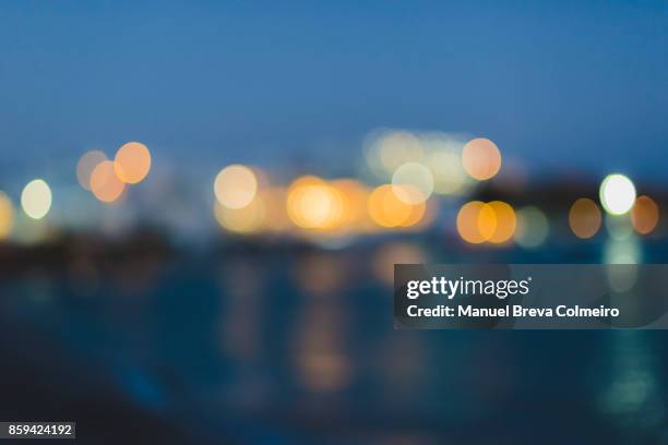abstract multicolored defocused lights - city night background stock pictures, royalty-free photos & images
