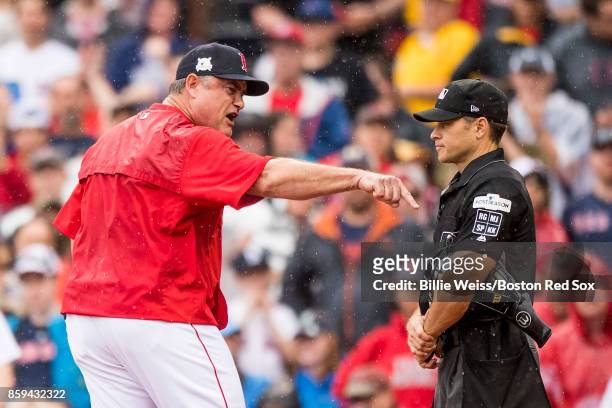 Manager John Farrell of the Boston Red Sox argues with home plate umpire Mark Wegner during the second inning of game four of the American League...