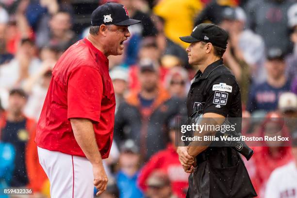 Manager John Farrell of the Boston Red Sox argues with home plate umpire Mark Wegner during the second inning of game four of the American League...