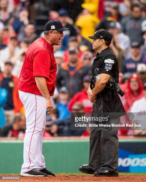 Manager John Farrell of the Boston Red Sox argues with home plate umpire Mark Wegner during the second inning of game four of the American League...