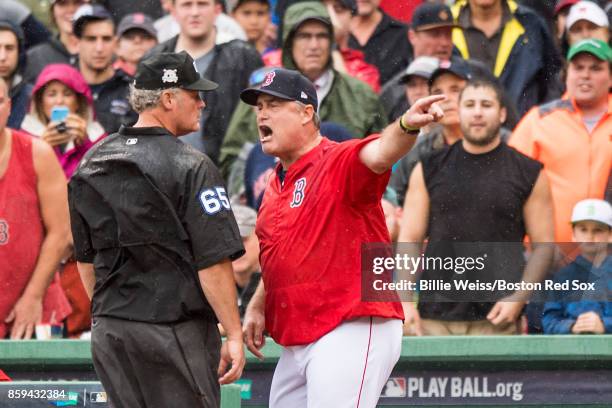 Manager John Farrell of the Boston Red Sox argues with umpire Ted Barrett during the second inning of game four of the American League Division...