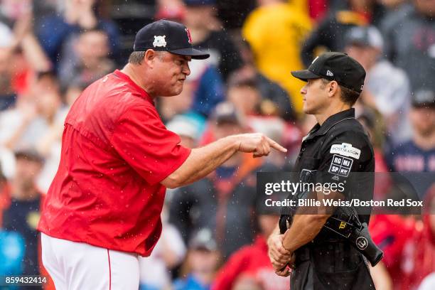 Manager John Farrell of the Boston Red Sox argues with home plate umpire Mark Wegner during the second inning of game four of the American League...