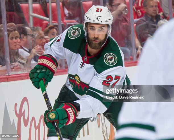 Kyle Quincey of the Minnesota Wild passes the puck against the Detroit Red Wings during the first ever NHL game at the new Little Caesars Arena on...