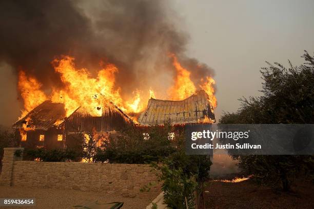 Fire consumes a barn as an out of control wildfire moves through the area on October 9, 2017 in Glen Ellen, California. Tens of thousands of acres...