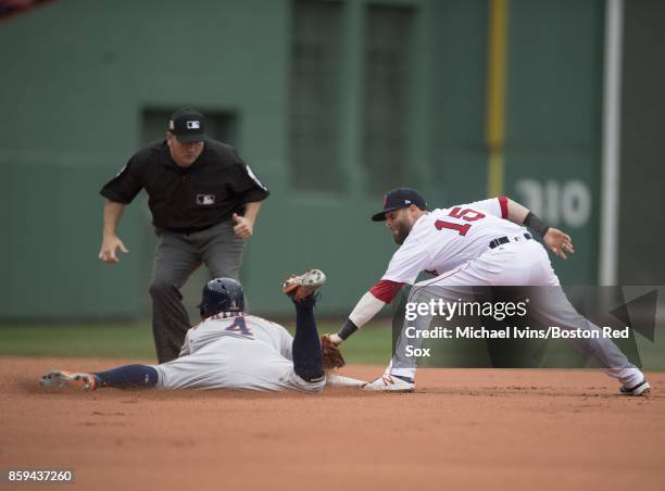 Dustin Pedroia of the Boston Red Sox tags out George Springer of the Houston Astros in the first inning of game four of the American League Division...