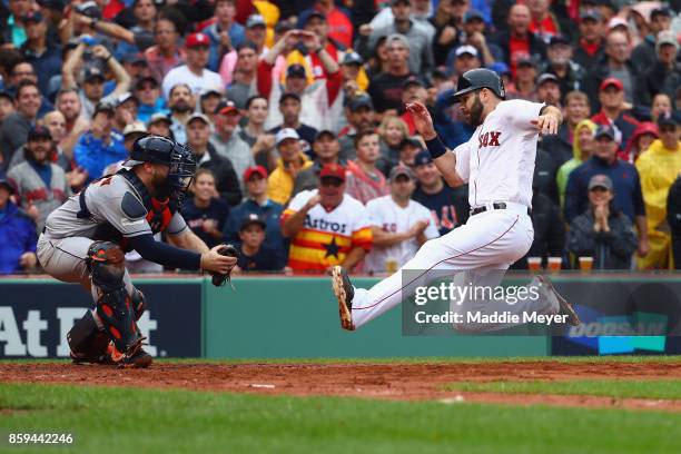 Mitch Moreland of the Boston Red Sox slides into home plate before being tagged out by Brian McCann of the Houston Astros to end the third inning...