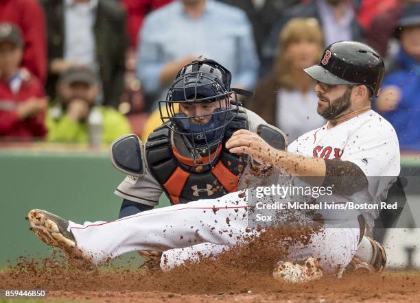 Brian McCann of the Houston Astros tags out Mitch Moreland of the Boston Red Sox in the third inning of game four of the American League Division...